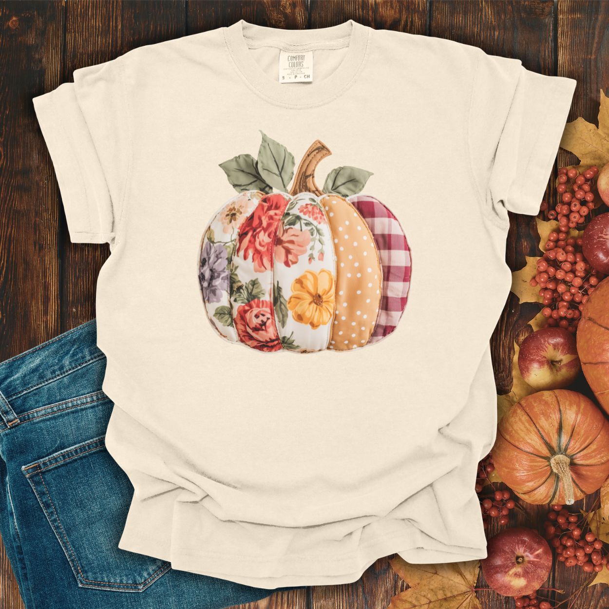Ivory Comfort Colors tee with a floral & plaid faux patchwork pumpkin design, S size.