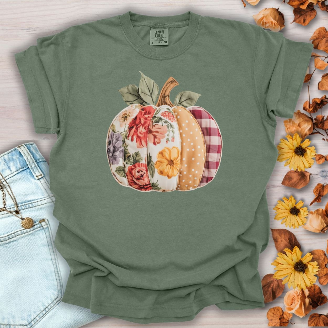 Moss green Comfort Colors tee with a faux patchwork pumpkin in floral, plaid, and polka dot patterns.