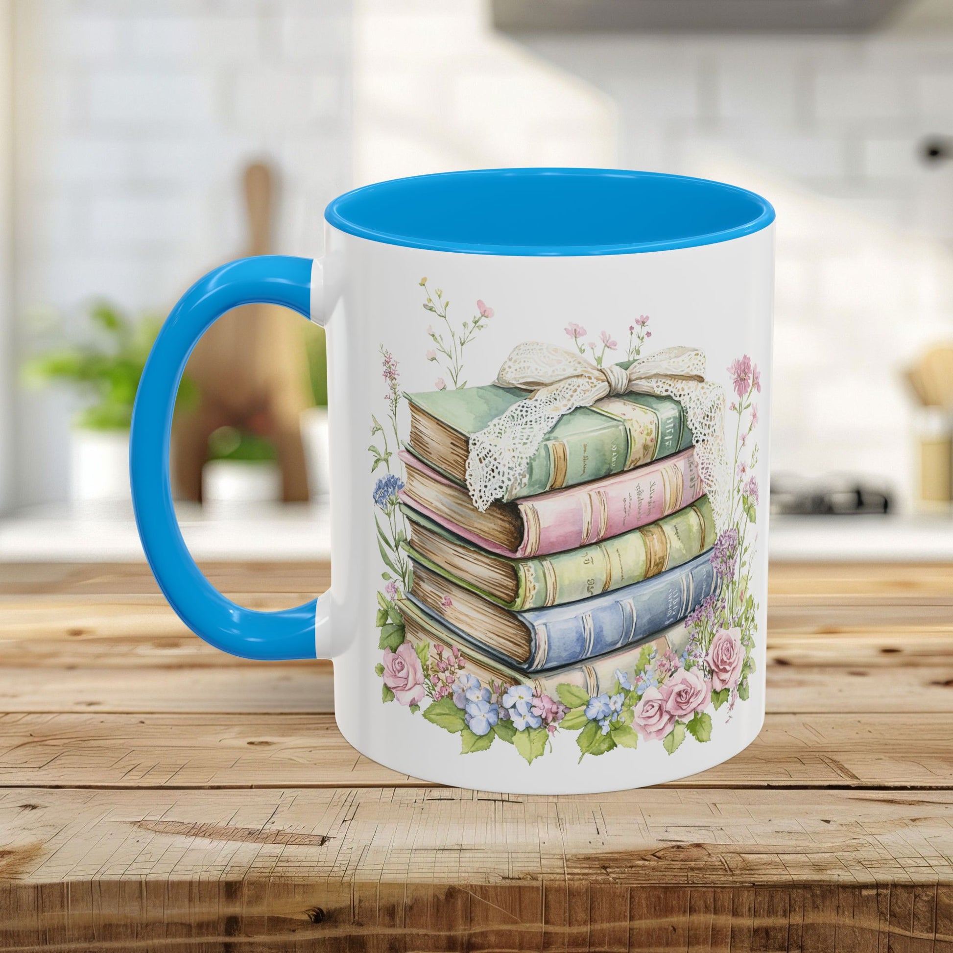White ceramic mug with blue interior and handle, featuring a watercolor stack of vintage books and roses.