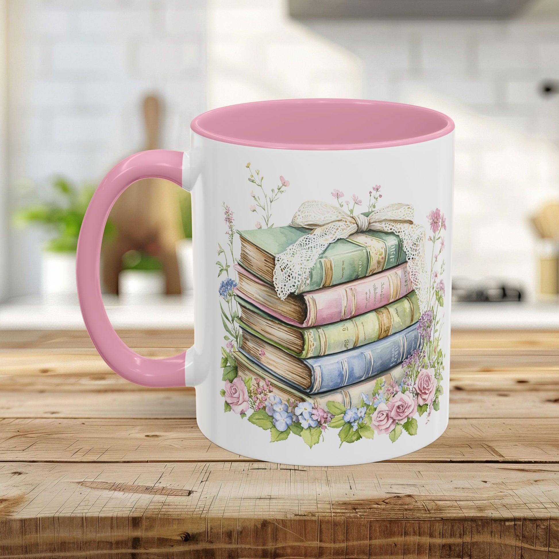 White ceramic mug with pink interior and handle, featuring a watercolor stack of vintage books and roses.