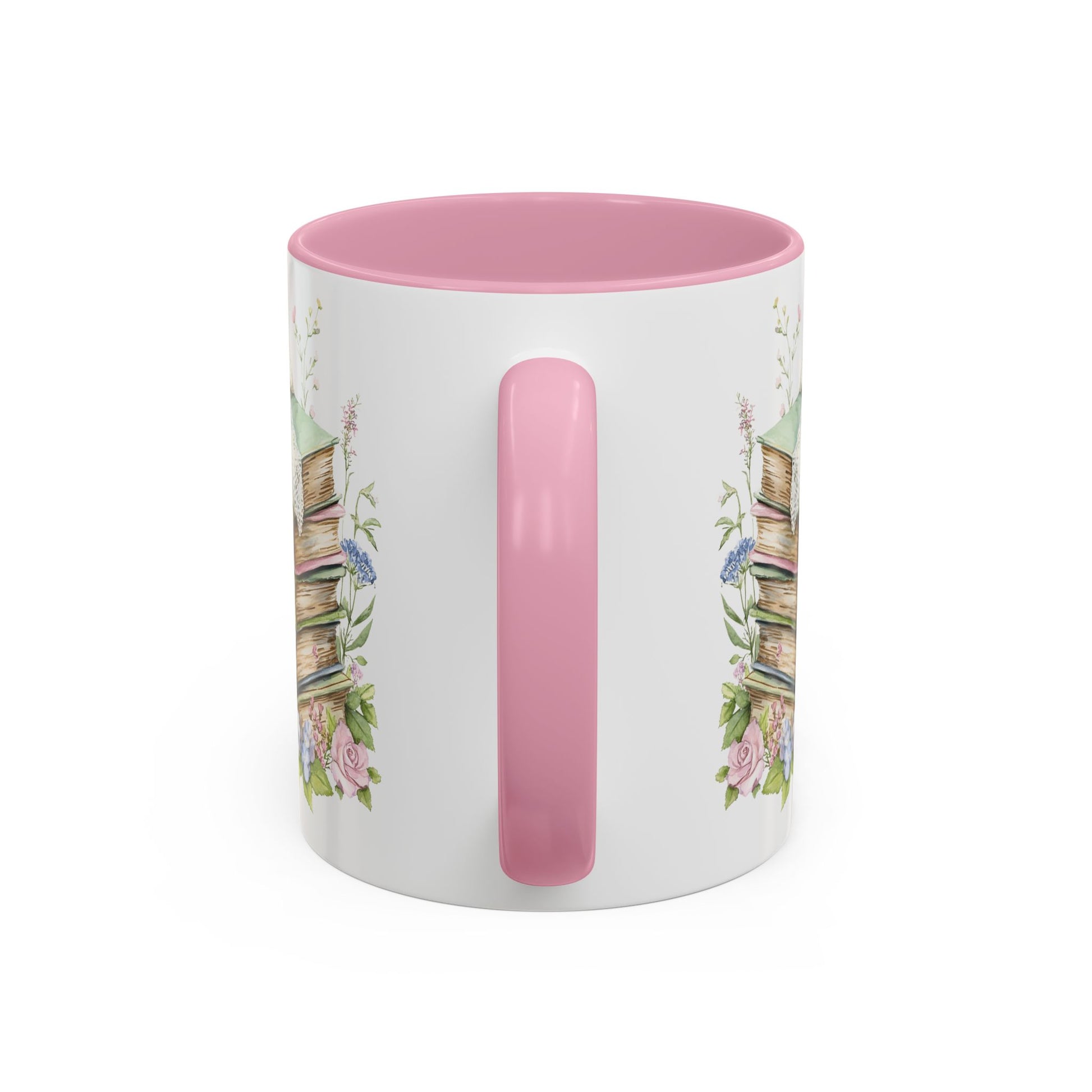 White ceramic mug with pink interior and handle, featuring a watercolor stack of vintage books and delicate roses.
