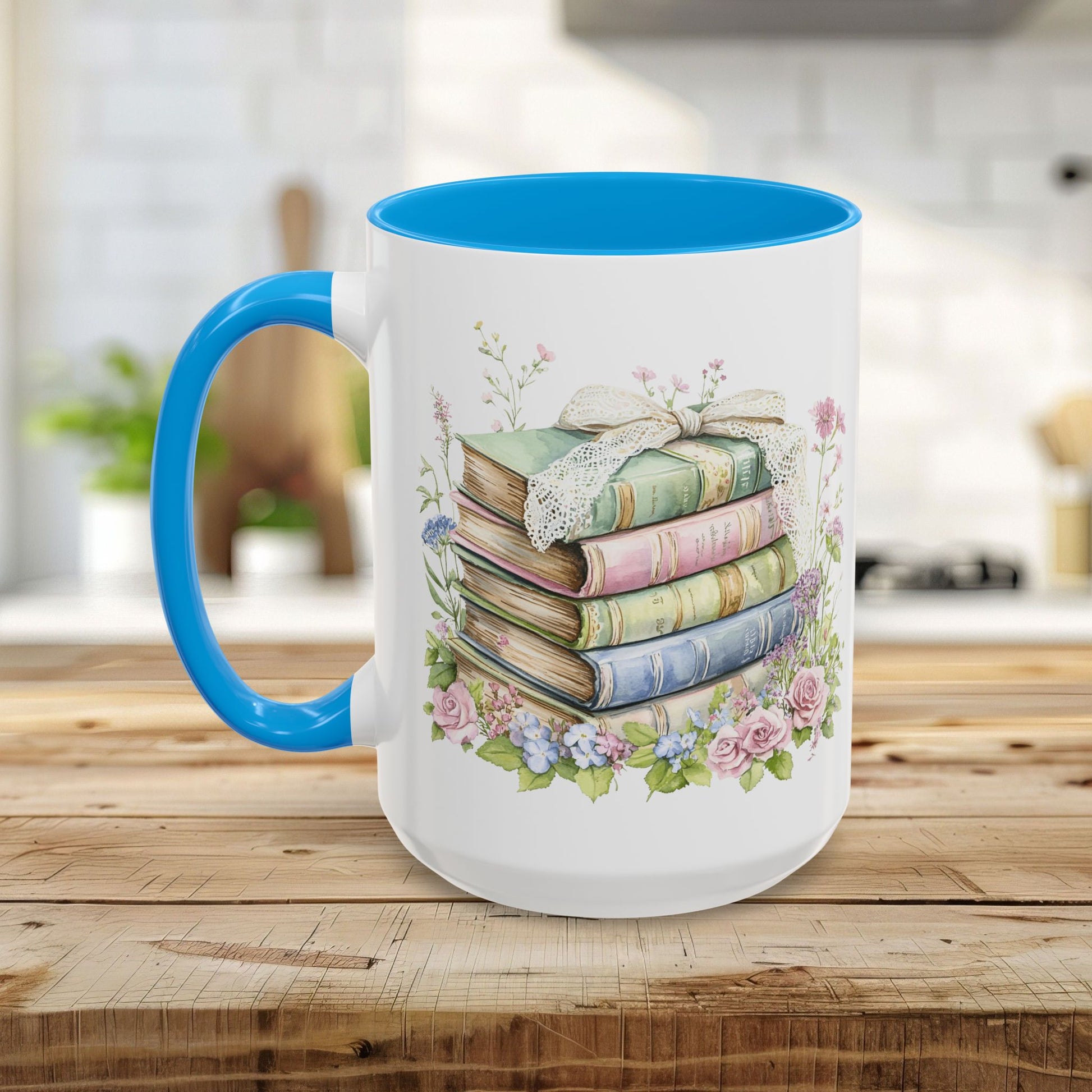 White ceramic mug with a blue handle and interior, featuring a watercolor stack of vintage pastel books and roses.