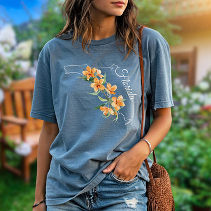 Garment-dyed blue t-shirt with a white Florida state outline and orange blossom design.