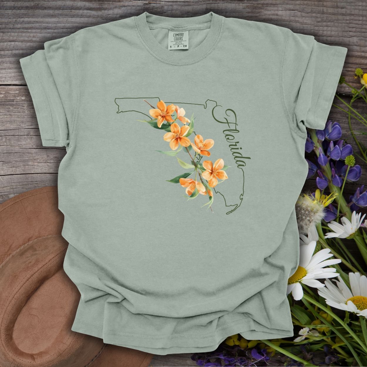 Bay S garment-dyed t-shirt with Florida state outline, orange blossoms, and "Florida" script.