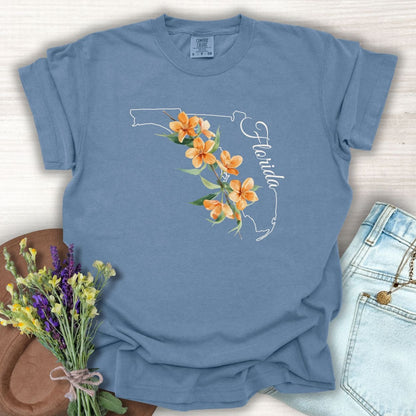 Blue Jean S t-shirt with white Florida outline, orange blossoms, and "Florida" script.