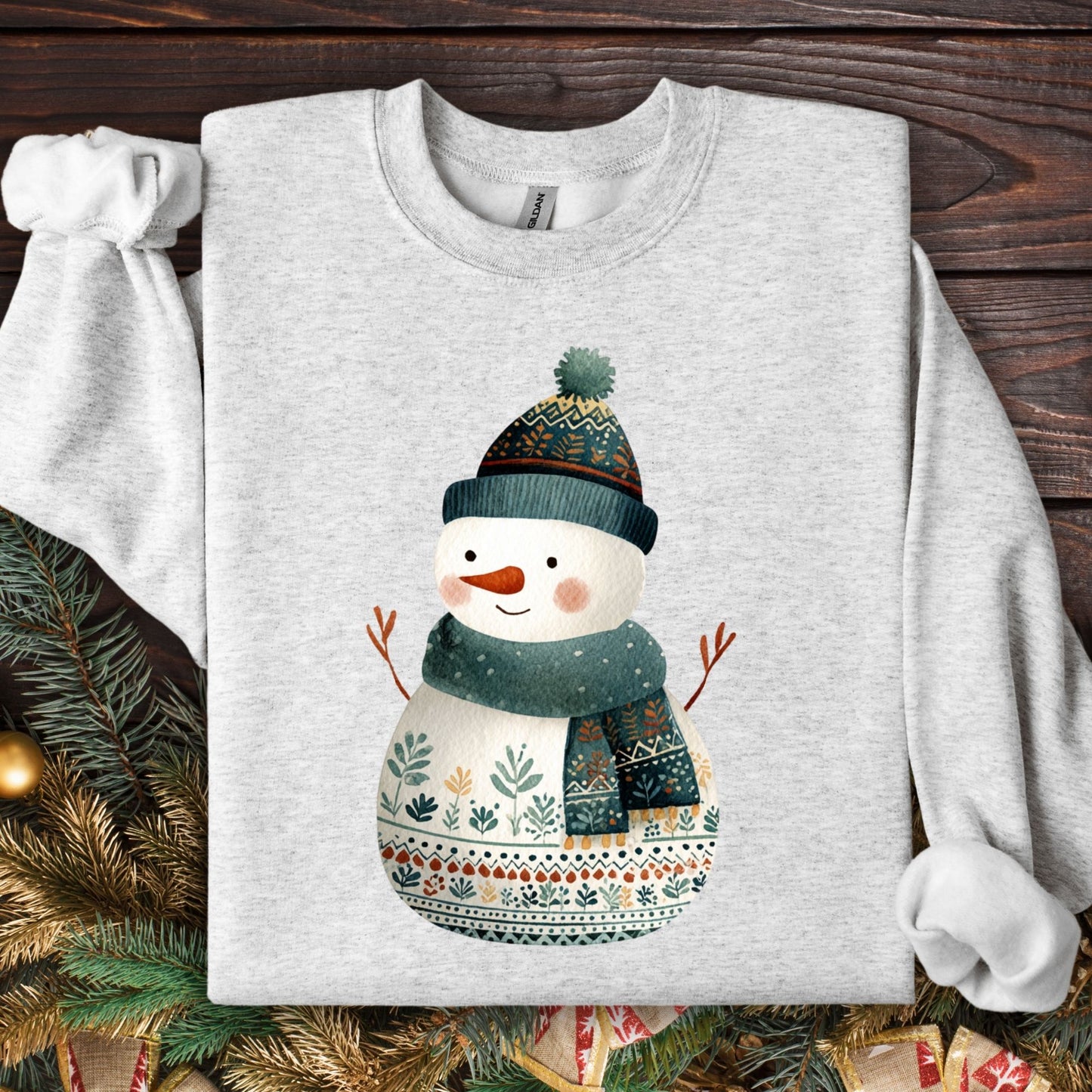 Ash gray Gildan crewneck sweatshirt with a folk art snowman in a teal hat and scarf.