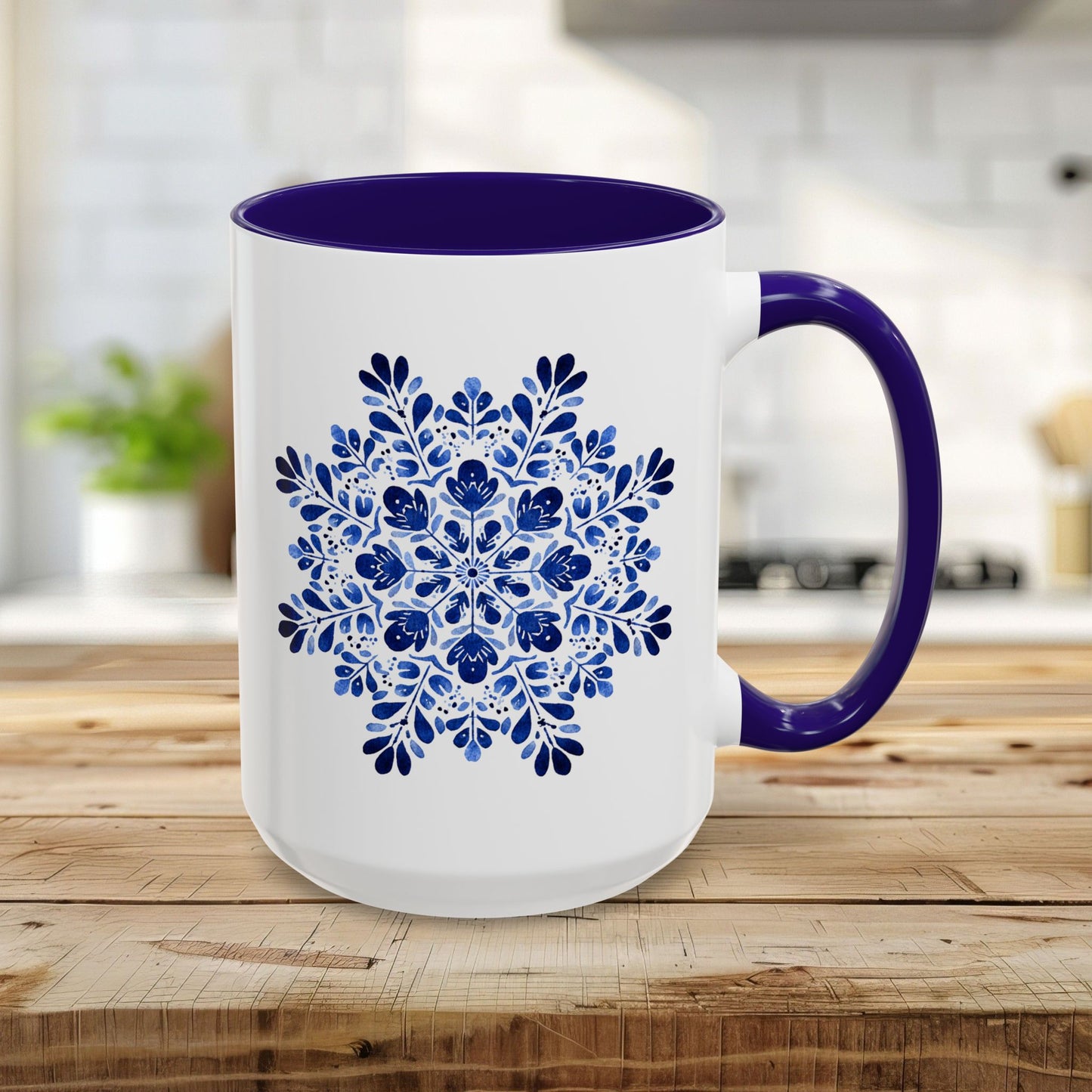 15oz white ceramic mug with navy interior and handle, featuring a detailed blue floral snowflake mandala.