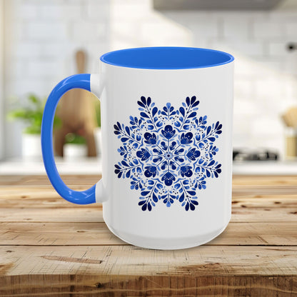 White ceramic 15oz mug with a blue interior and handle, featuring a detailed blue floral snowflake mandala.