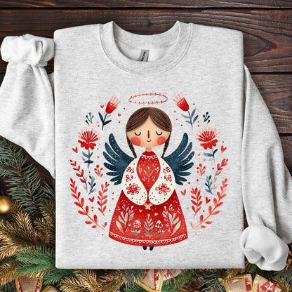 Ash Gildan sweatshirt with a folk art Christmas angel in red, green, and navy, surrounded by floral details.