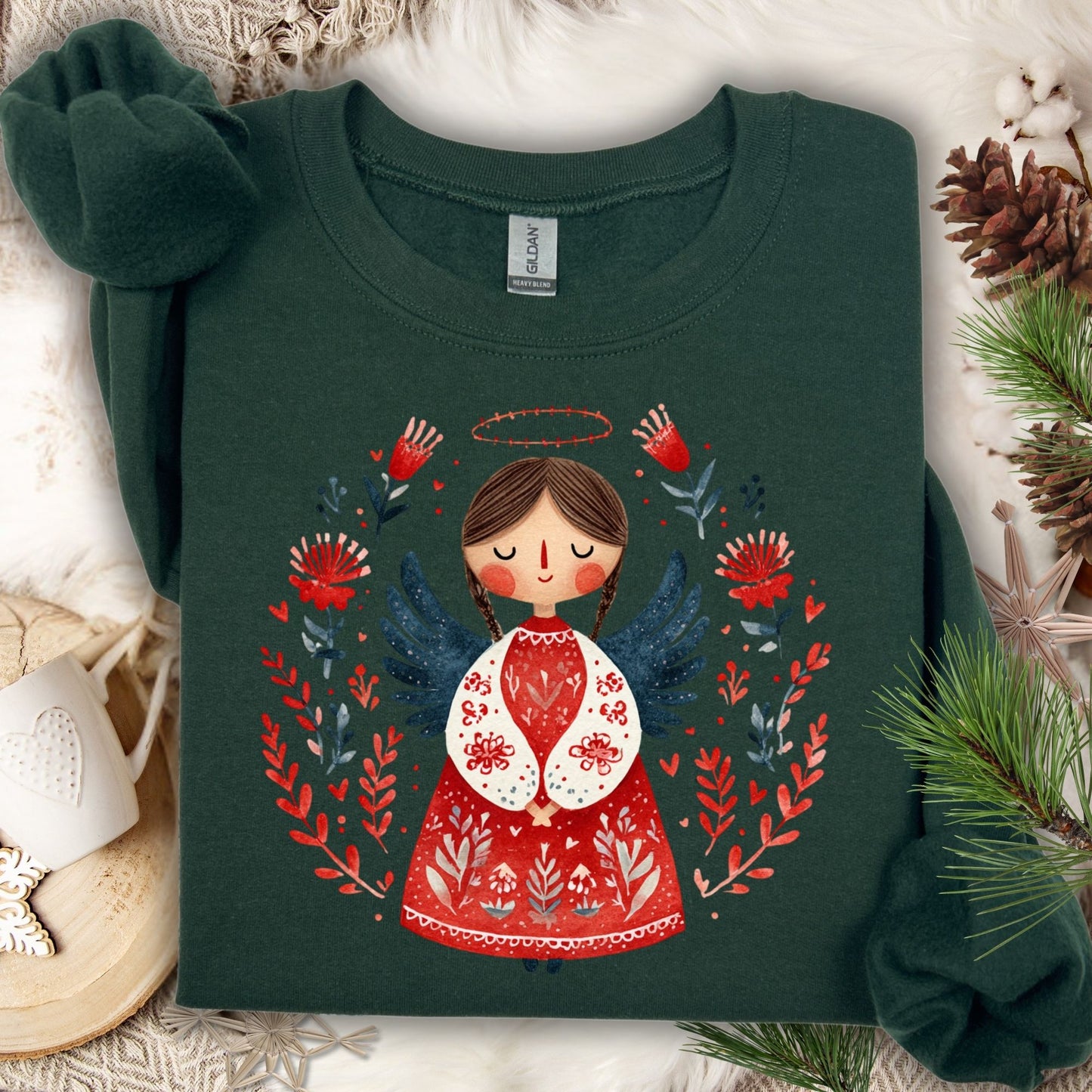 Forest green Gildan sweatshirt with a folk art Christmas angel design surrounded by red and blue florals.