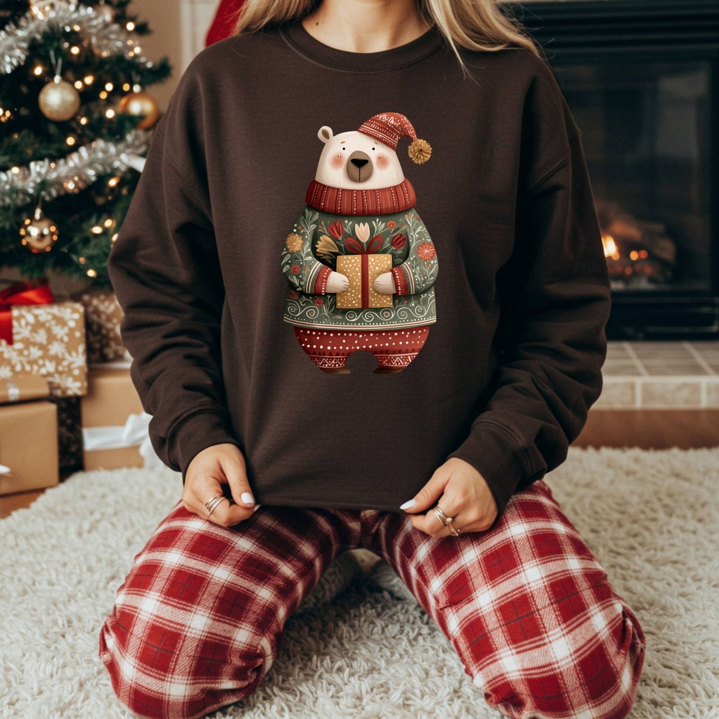 Brown Gildan crewneck sweatshirt with a folk art polar bear in a fair isle sweater, holding a gift.