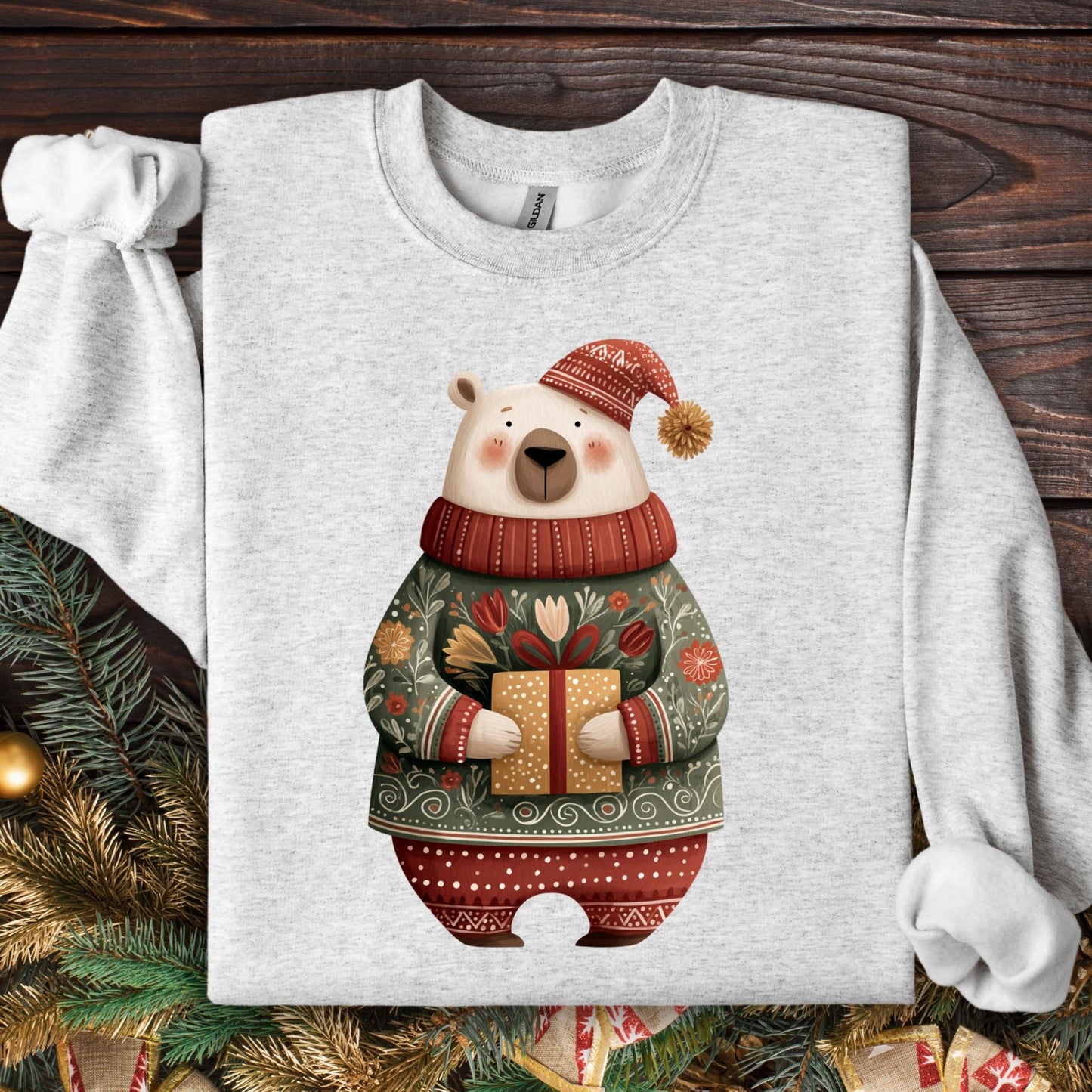 Ash Gildan crewneck sweatshirt with a folk art polar bear in a fair isle sweater holding a gift.