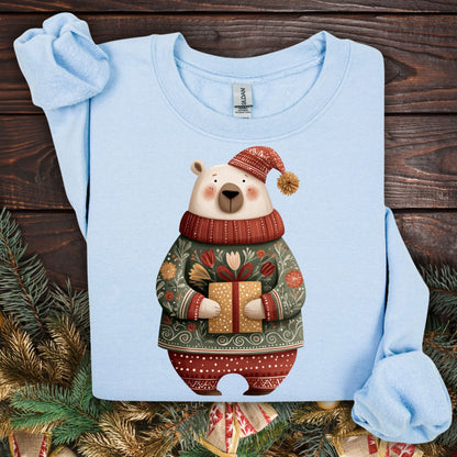 Light blue Gildan crewneck sweatshirt with a folk art polar bear in a fair isle sweater holding a gift.