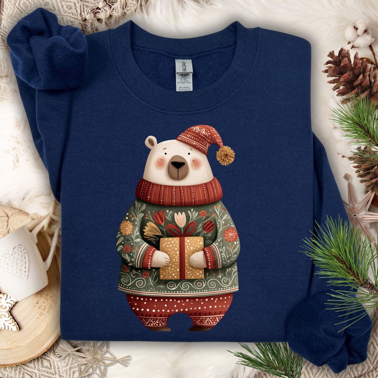 Navy Gildan crewneck sweatshirt with a folk art polar bear in a fair isle sweater, holding a gift.