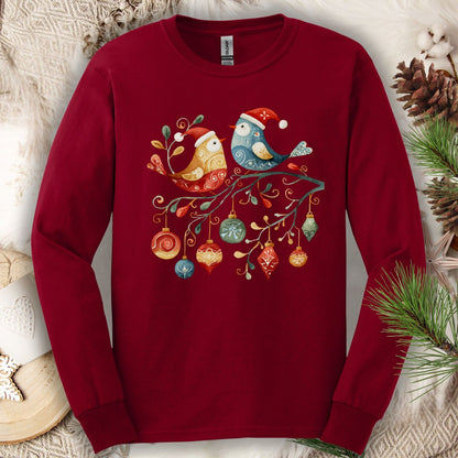 Cardinal red long sleeve tee with folk art birds in Santa hats on a festive branch with ornaments.