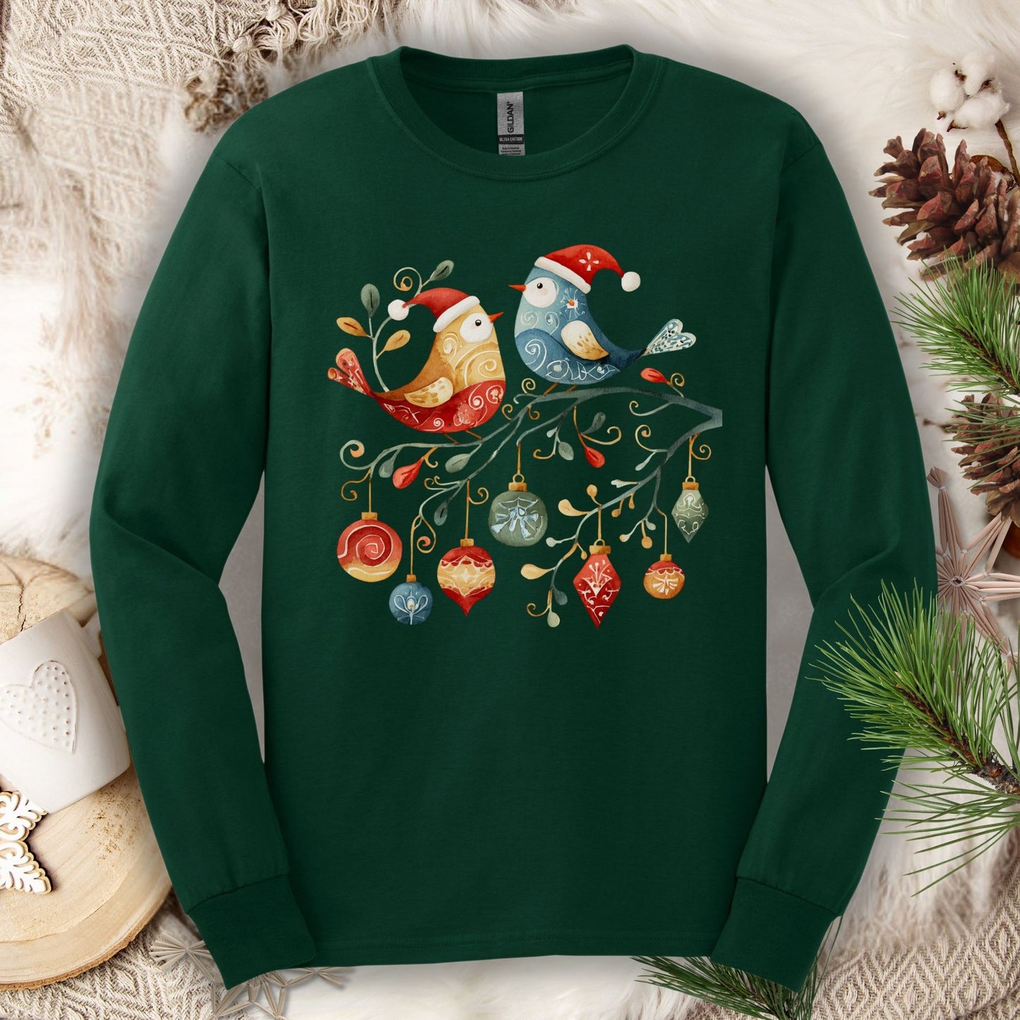 Forest green Gildan long sleeve tee with folk art Christmas birds and ornaments on a branch.