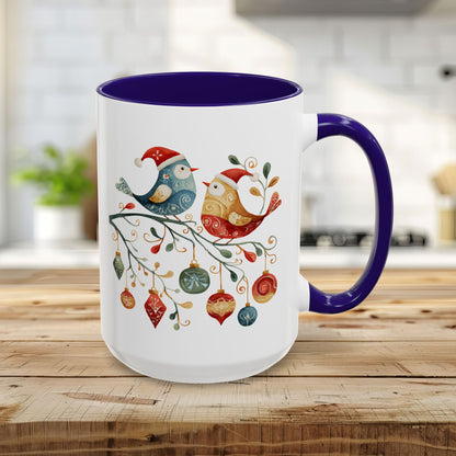 15oz ceramic mug with blue interior/handle and folk art Christmas birds on a festive branch.