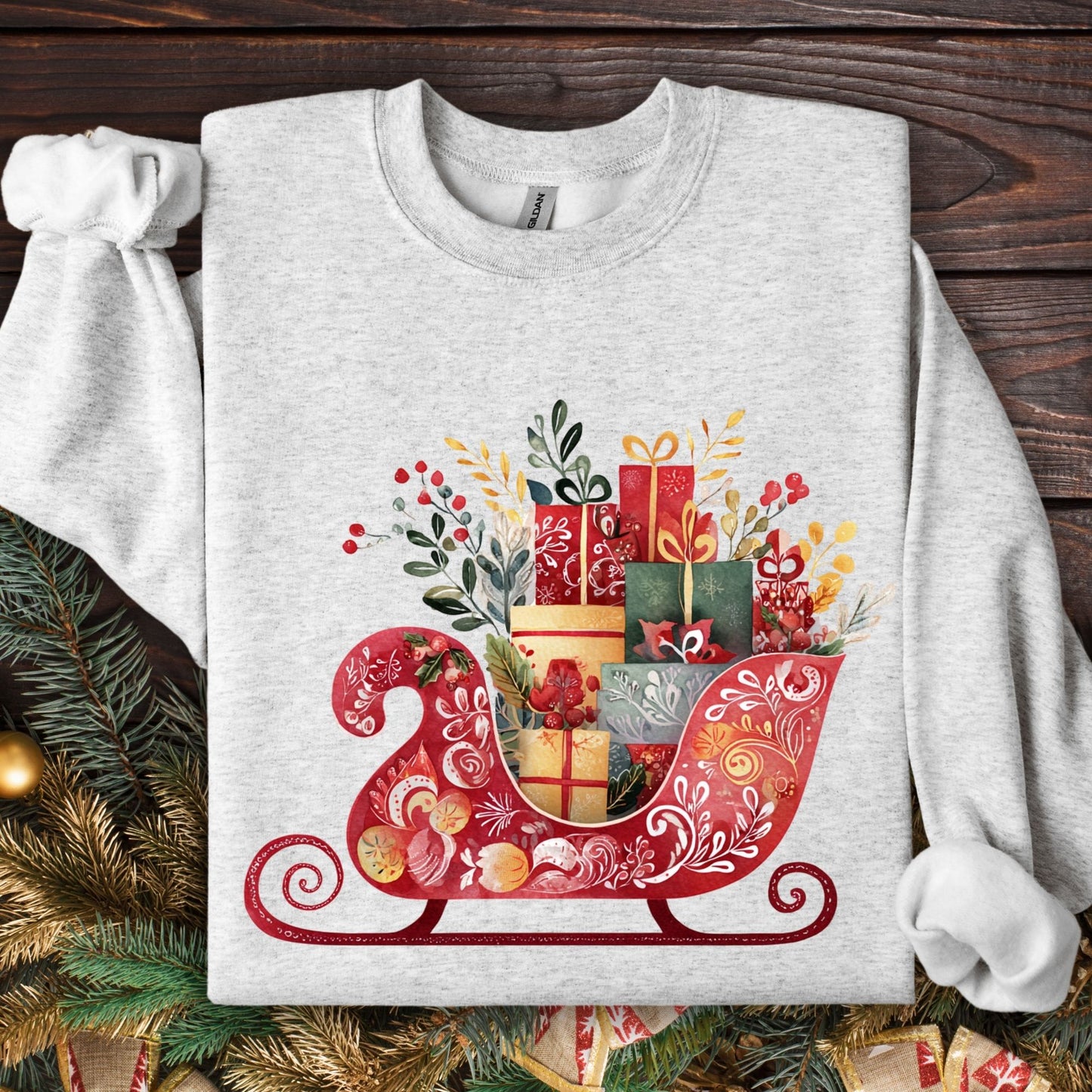 Ash Gildan 18000 sweatshirt with folk art Christmas sleigh brimming with gifts in garnet, gold, forest green.
