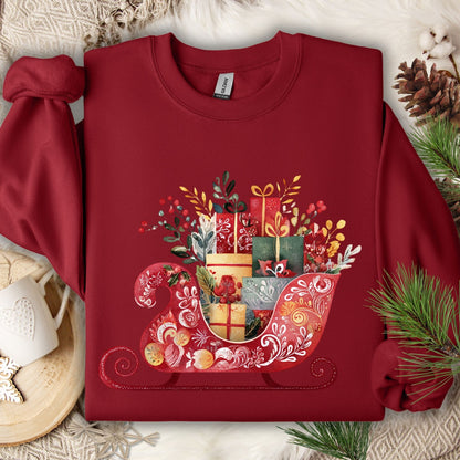 Garnet red Gildan crewneck sweatshirt with folk art Christmas sleigh brimming with gifts.