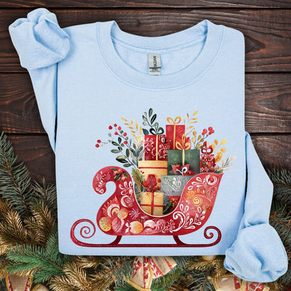 Light blue Gildan crewneck sweatshirt with folk art red sleigh brimming with colorful Christmas gifts.