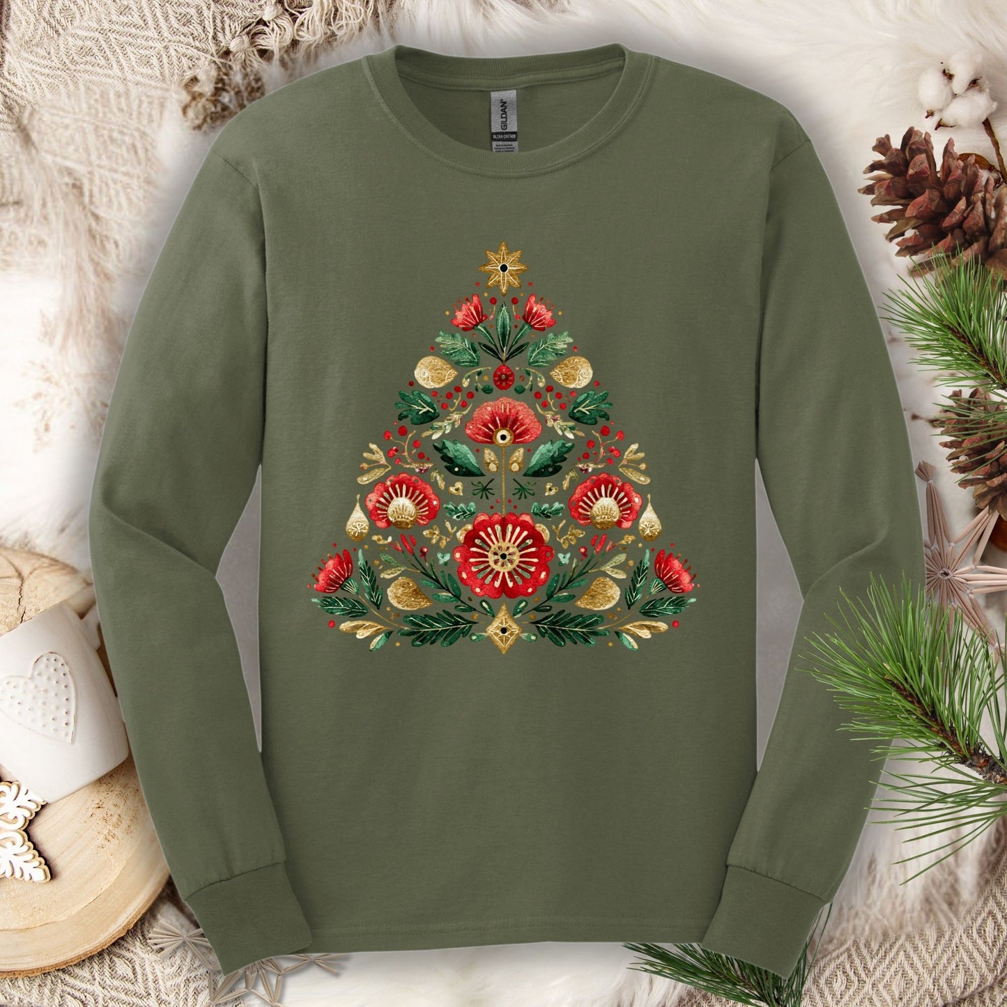 Military green long sleeve tee with a folk art Christmas tree design in red, green, and gold.