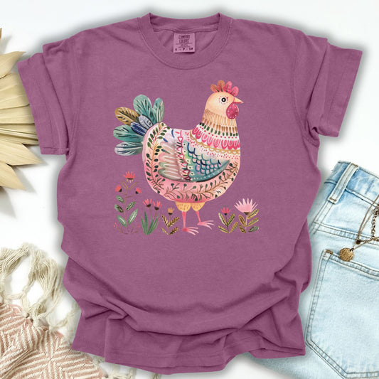 Berry S folk art chicken t-shirt with colorful hen and garden motifs, made from garment-dyed cotton.