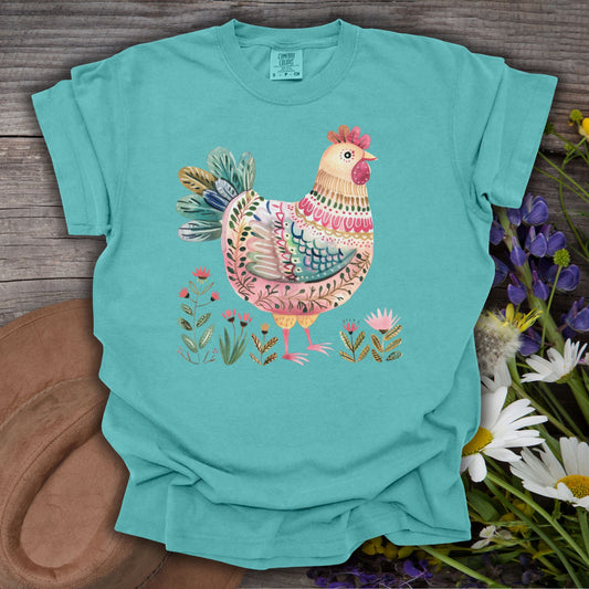 Seafoam S t-shirt with a colorful folk art hen and garden motifs, made from garment-dyed cotton.