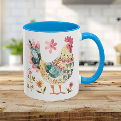 11oz ceramic mug with a light blue handle and interior, featuring a colorful folk art watercolor rooster and floral design.