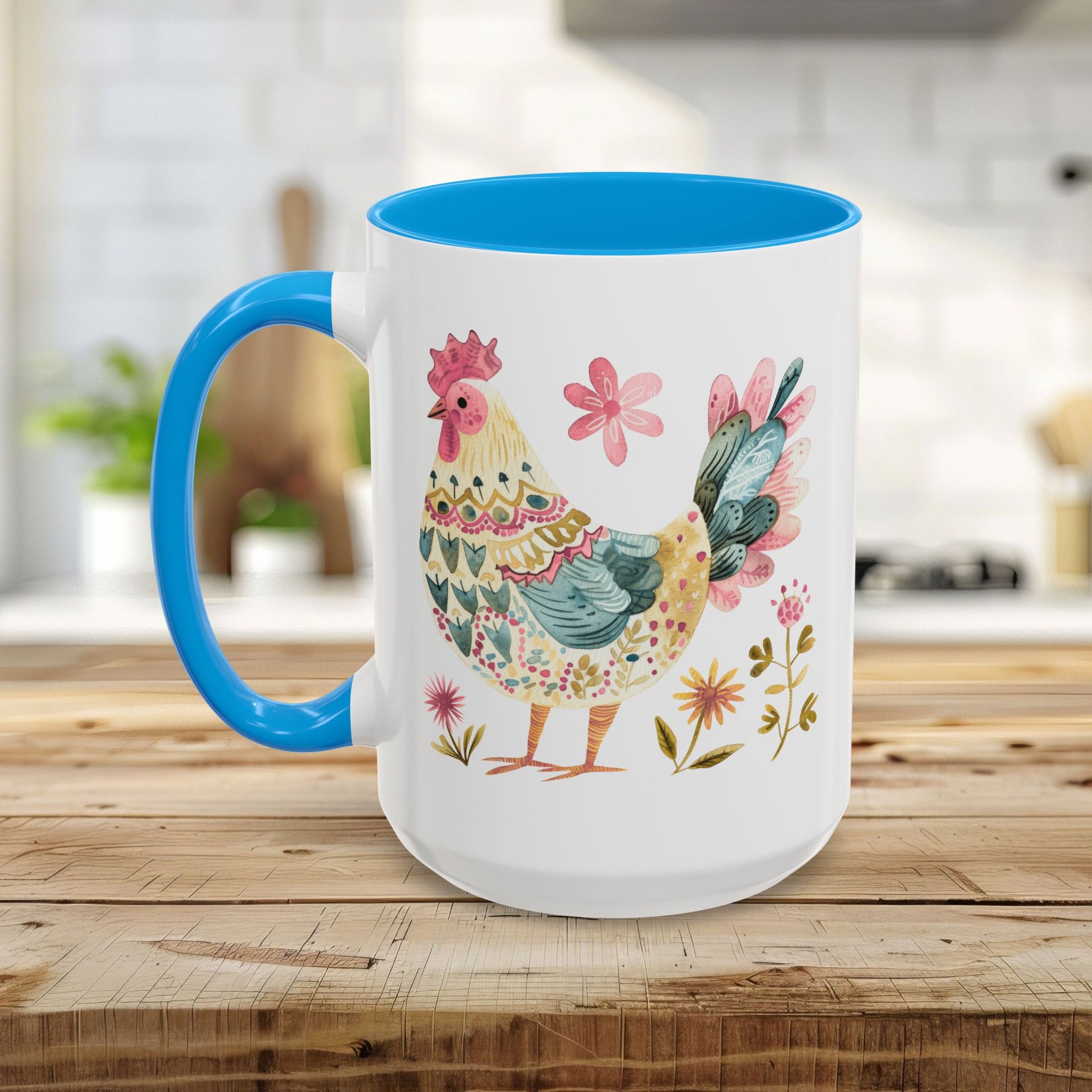 White ceramic mug with blue handle and interior, featuring a colorful folk art watercolor rooster and floral design.