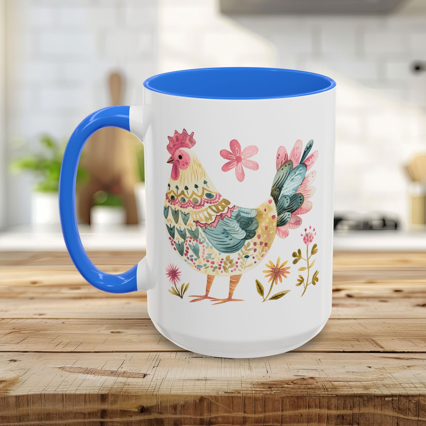 White ceramic mug with blue handle and interior, featuring a colorful folk art watercolor rooster and floral design.