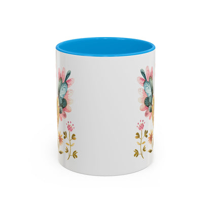 White ceramic mug with blue interior, featuring watercolor folk art flowers on the sides.