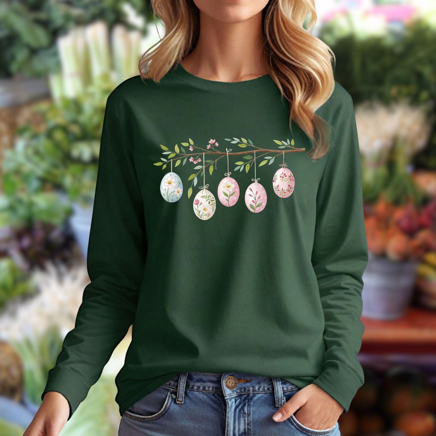 Dark green long-sleeve tee with a folk art branch, five hanging Easter eggs, and floral designs.