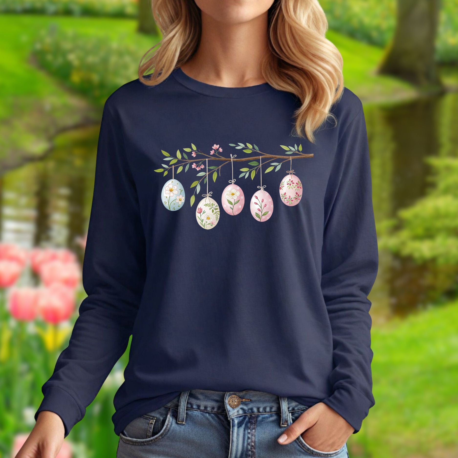 Navy long-sleeve tee with a folk art branch, five watercolor Easter eggs, and floral designs.