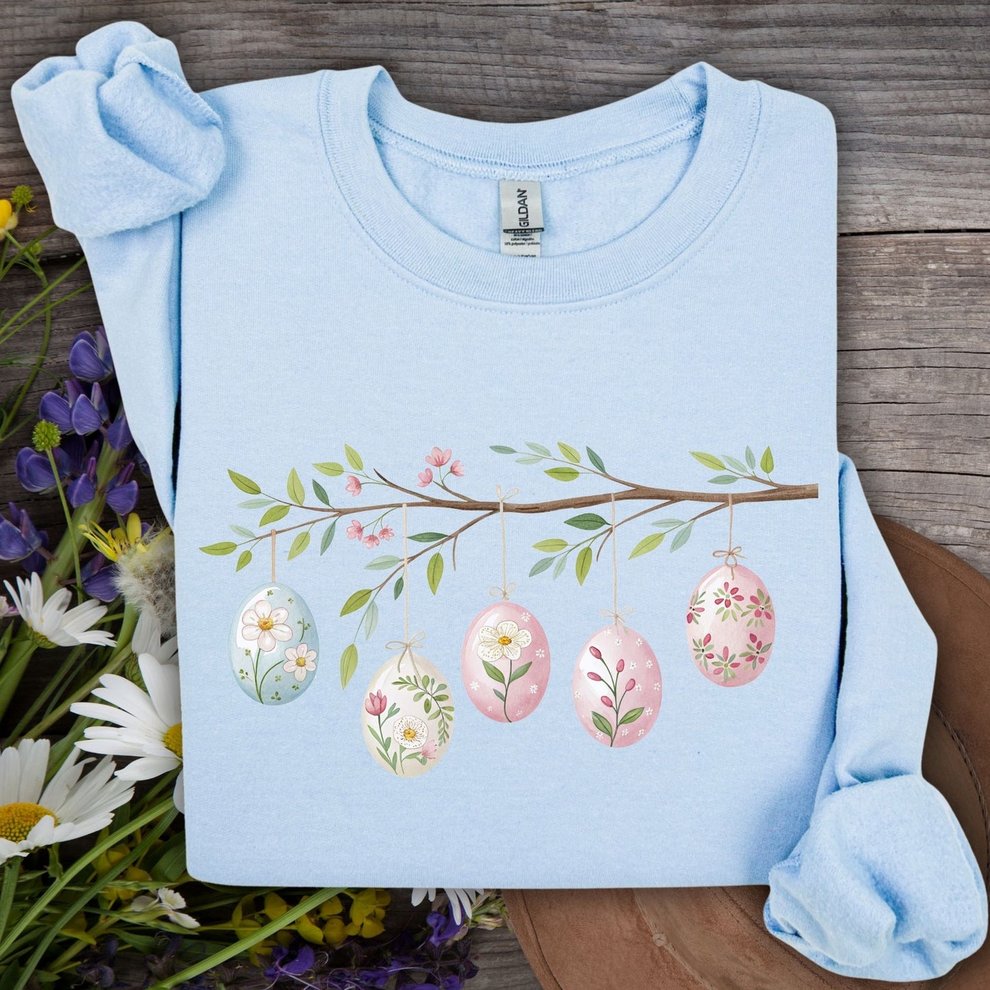 Light blue cotton-poly sweatshirt with a folk art Easter egg branch design.