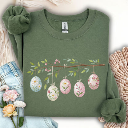 Military green sweatshirt with a folk art Easter egg branch design featuring watercolor botanical eggs.