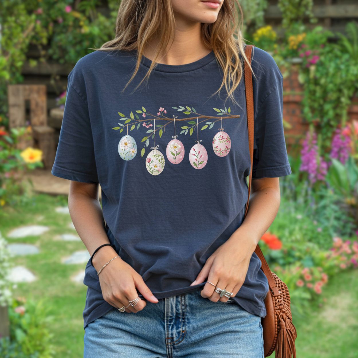 Navy blue relaxed-fit t-shirt with a folk art branch design featuring five pastel Easter eggs.