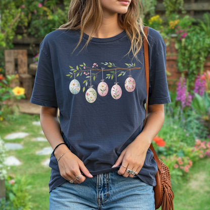 Navy blue relaxed-fit t-shirt with a folk art branch design featuring five pastel Easter eggs.