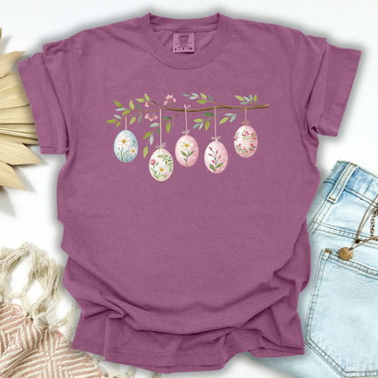 Berry S t-shirt with a folk art branch and five watercolor Easter eggs hanging from it.