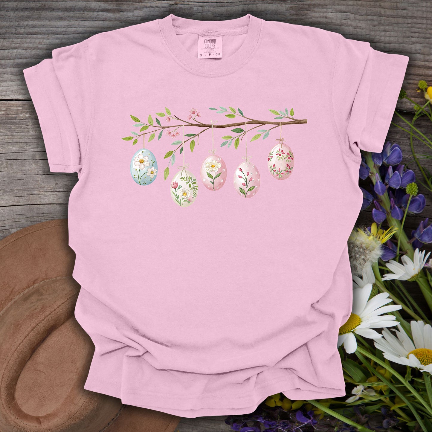 Blossom pink S-sized t-shirt with a folk art branch and watercolor Easter eggs.