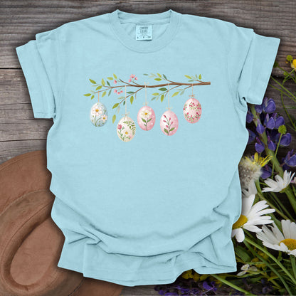Chambray blue garment-dyed cotton t-shirt with a folk art Easter egg branch design.