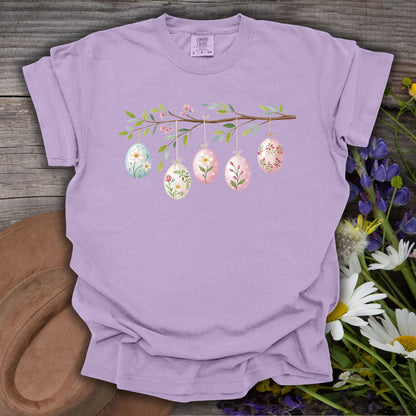 Orchid S-size t-shirt with a folk art Easter egg branch design, featuring watercolor eggs and blooms.