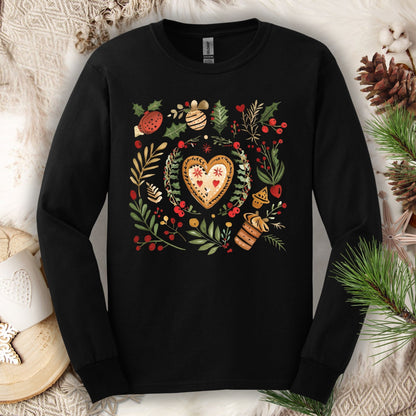 Black Gildan long sleeve tee with folk art gingerbread heart, holly, and vintage baking design.