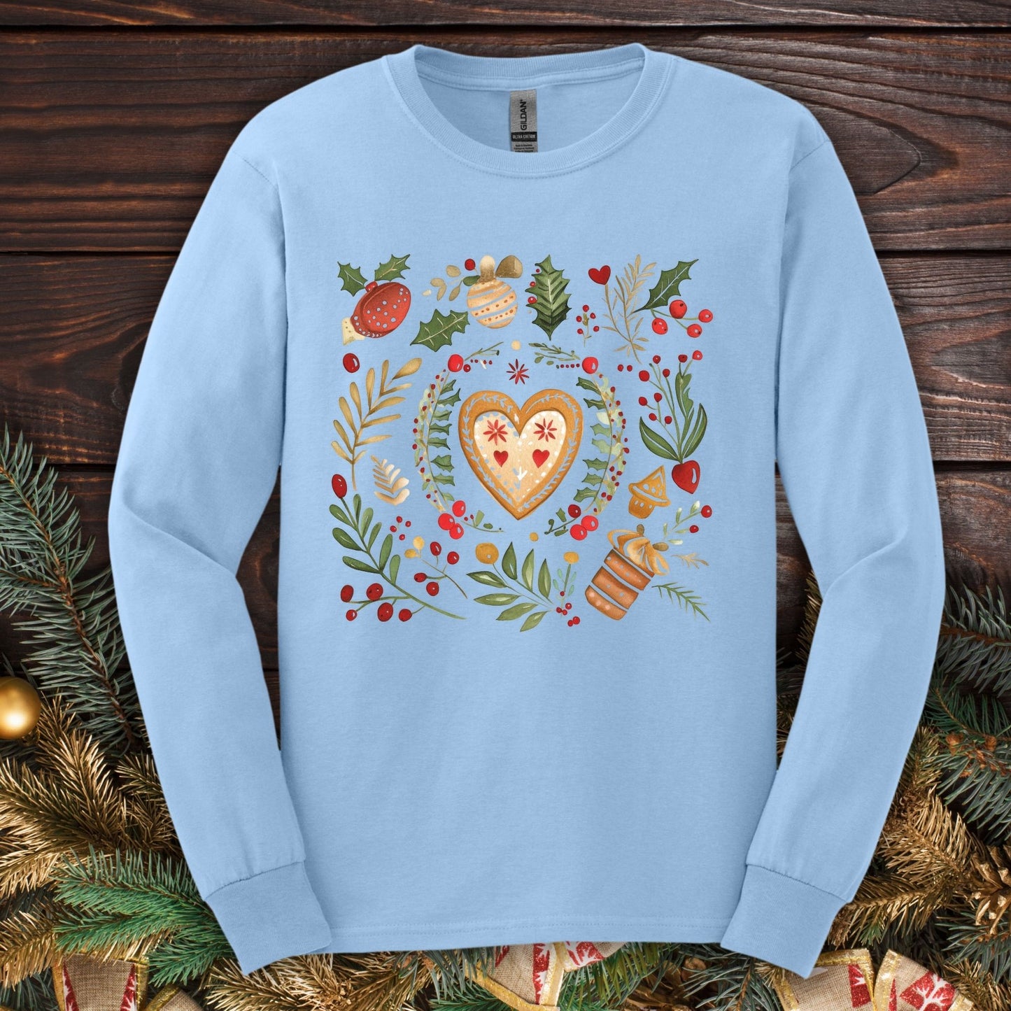 Light blue Gildan Softstyle long sleeve tee with folk art gingerbread heart, holly, and vintage baking design.
