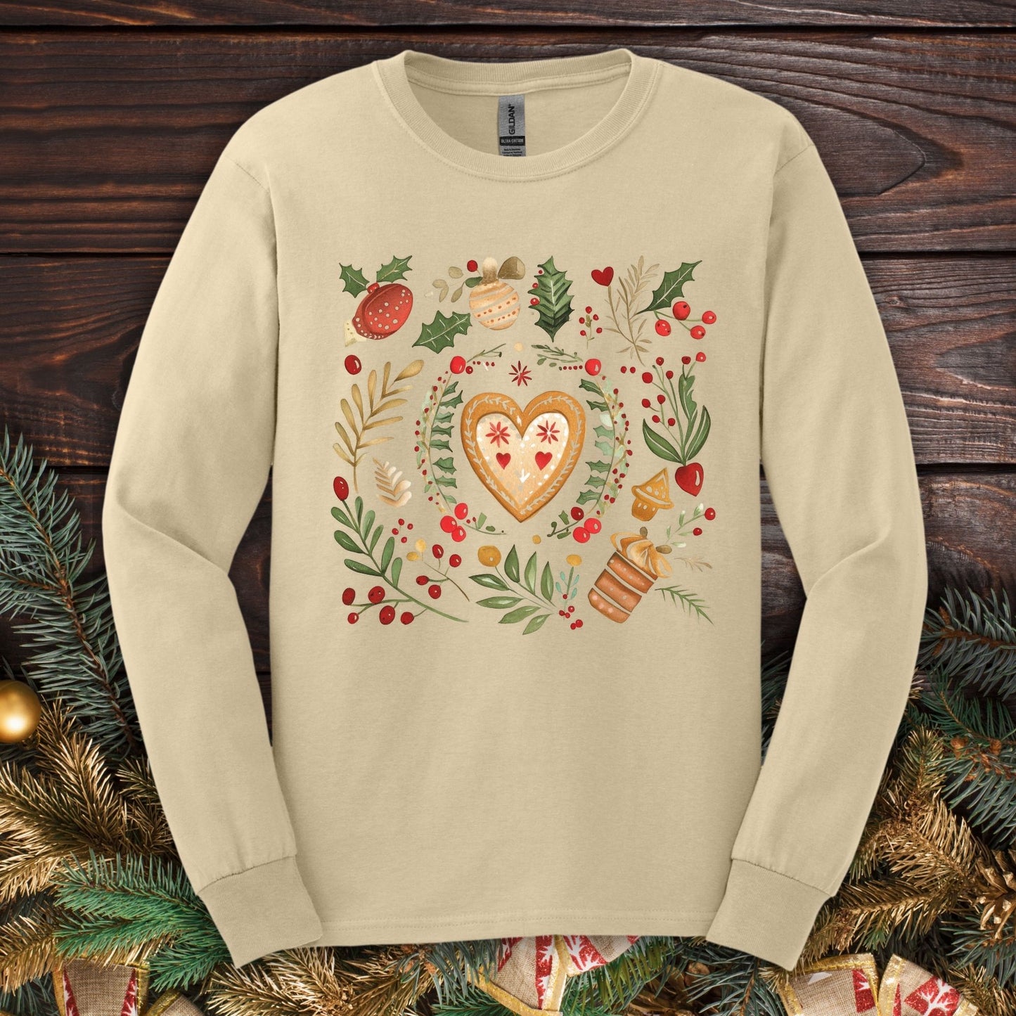 Sand Gildan Softstyle long sleeve tee with folk art gingerbread heart, holly, and vintage baking design.