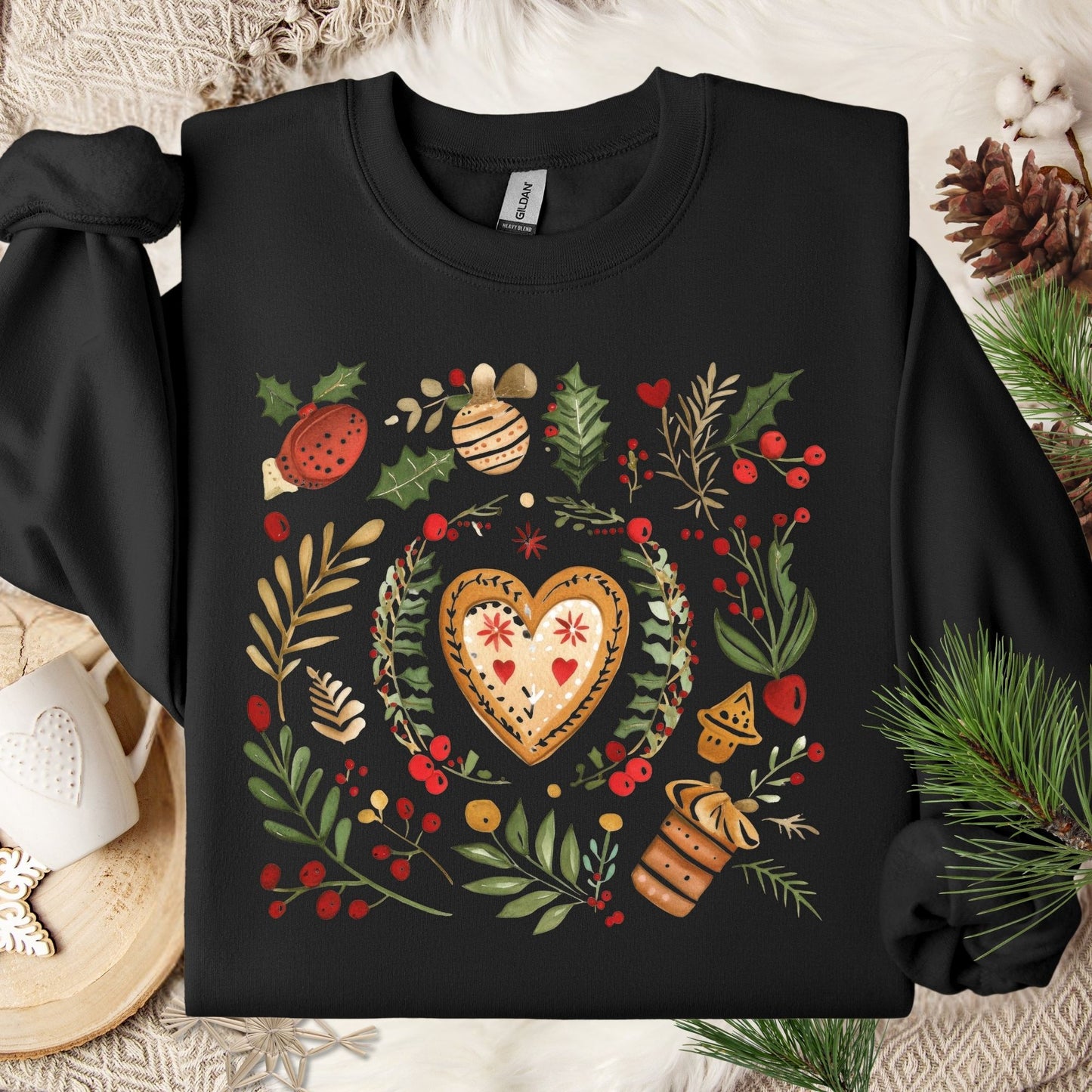 Black S sweatshirt with folk art gingerbread heart, holly, and red berry design.
