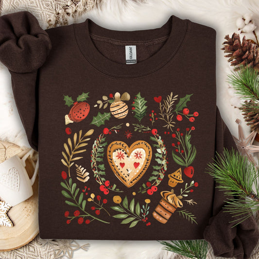 Dark chocolate Gildan sweatshirt with folk art gingerbread heart, holly, and berries design.