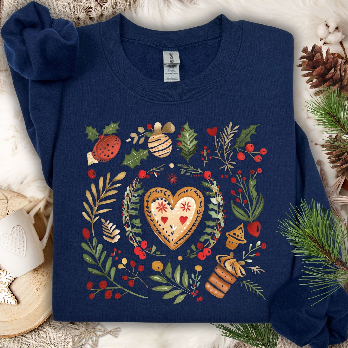 Navy S sweatshirt with folk art gingerbread hearts, red accents, and holly sprigs on soft fleece.