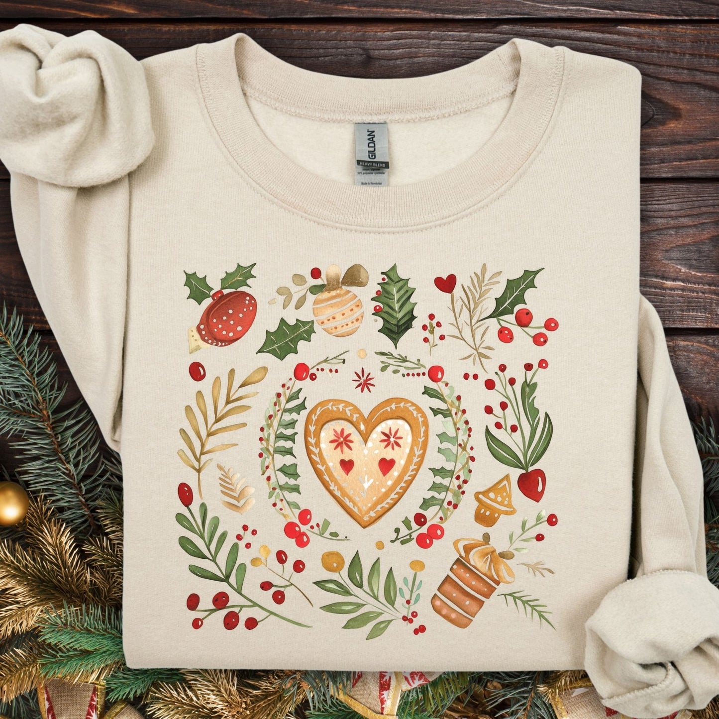 Sand colored fleece sweatshirt with folk art gingerbread heart, holly, and red berry design.