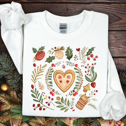 White S sweatshirt with folk art gingerbread heart, holly, and red berry design.