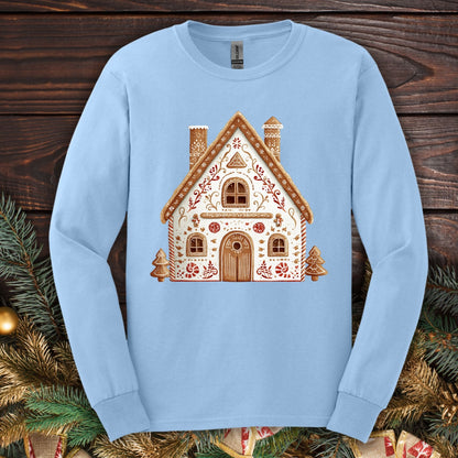 Light blue Gildan long sleeve tee with a folk art gingerbread house design in soft watercolor tones.